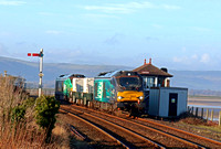 DRS 68003 'Astute' leads 2 Nuclear Flasks with DRS 68006 in green livery (HVO fuel) at rear on 11.1.22 passes Arnside Signal Box with 6C51 1247 Sellafield B.N.F. to Heysham Harbour P.S. working