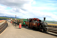 Double Fairlie 'Merddin Emrys' arrives at Porthmadog station, Ffestiniog and Welsh Highland Railways on 11.6.24 with 1625 Bl. Ffestiniog to Porthmadog  'Woodland Wanderer' service