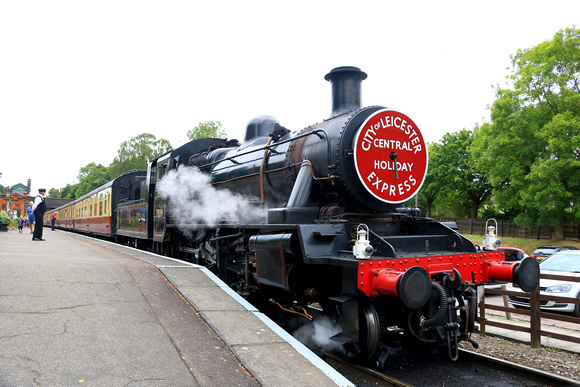 BR Standard Class 2 2-6-0 No 78019 waits at Rothley station on 6.8.24 with 1155 Loughborough to Leicester North midweek service with a holiday express headboard