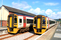 TfW Class 158 No 158828 arrives at Tywyn station on 6.6.24 with 2J19 1408 Birmingham International to Pwllheli passing TfW Class 158 No 158820 waiting with 2G65 1537 Pwllheli to Machynlleth service