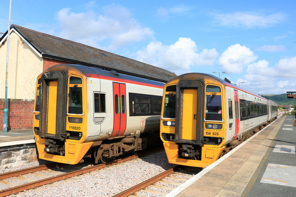 TfW Class 158 No 158828 arrives at Tywyn station on 6.6.24 with 2J19 1408 Birmingham International to Pwllheli passing TfW Class 158 No 158820 waiting with 2G65 1537 Pwllheli to Machynlleth service