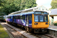 Preserved Pacer Class 142 No 142078 waits at Stanhope station, Weardale Railway on 28.9.24 with 1410 service to Bishop Auckland West service. Behind stabled is Class 122 DMBS E 55012