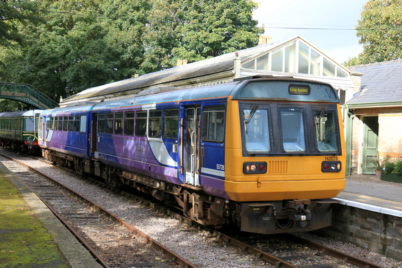 Preserved Pacer Class 142 No 142078 waits at Stanhope station, Weardale Railway on 28.9.24 with 1410 service to Bishop Auckland West service. Behind stabled is Class 122 DMBS E 55012