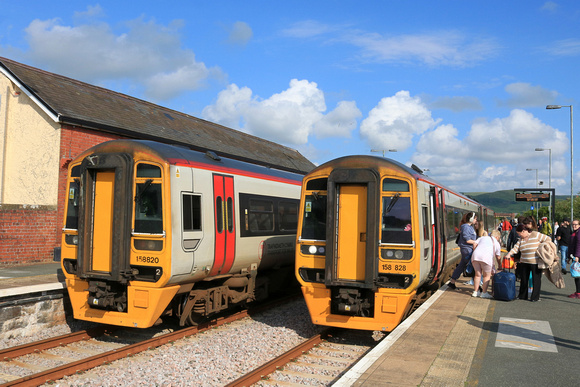 TfW Class 158 No 158828 at Tywyn station on 6.6.24 with 2J19 1408 Birmingham International to Pwllheli passing TfW Class 158 No 158820 waiting with 2G65 1537 Pwllheli to Machynlleth service