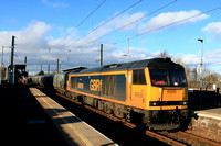 GBRf Class 60 No 60095 Whernside hurries through East Boldon Tyne & Wear Metro station on 25.1.25 with 6H70 1224 Tyne Coal Terminal Gbrf to Drax Aes (Gbrf) loaded Biomass hoppers