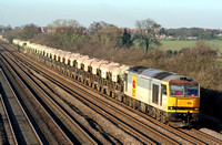 EWS 60076 in two tone grey livery at Cossington, MML heading towards Syston East Junction on  12.2.08 with  6E63 1510 Mountsorrel Sdgs - Peterborough loaded self discharge La Farge stone hoppers