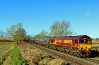 DB Cargo Class 66 No 66106 in old EWS livery passes Chellaston heading towards Castle Donington on 19.1.22 with 6E54  1104 Kingsbury Oil Sdgs to Humber Oil Refinery empty bogie oil tanks