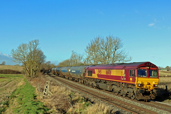 DB Cargo Class 66 No 66106 in old EWS livery passes Chellaston heading towards Castle Donington on 19.1.22 with 6E54  1104 Kingsbury Oil Sdgs to Humber Oil Refinery empty bogie oil tanks