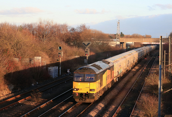 GBRf Class 60 No 60096 Skiddaw in ex Colas livery at Pelaw on 9.12.24 with 6N22 1404 Tyne Coal Terminal Gbrf to Lynemouth Power Stn (Gbrf) loaded Biomass hoppers passing alongside the Tyne and Wear Me