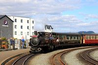 Double Fairlie 'James Spooner with Eryri-Snowdonia  a 1st class Pullman Observation carriage arrives  at Porthmadog station, Ffestiniog and Welsh Highland Railways with 1625 Bl. Ffestiniog to Porthmad