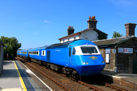 LSL Blue Midland Pullman with 43059 leading and 43055 on the rear passes through Valley station, Anglesey on 23.6.24 with 5Z48 1540 Holyhead Car. M.D. to Crewe H.S. ECS working from previous day's tou