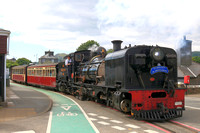 South African NG G16 No.87 steams along High Street. Porthmadog on 12.6.24 with 1540 Beddgelert  to Porthmadog 'The Aberglaslyn'  service on the Ffestiniog and Welsh Highland Railways