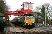 Freightliner Class 66 No 66537 passes beneath the overhead Wylam station signal box on 28.1.25 about to cross the station level crossing with 6E48 1020 Carlisle N.Y. to Tyne S.S. departmental