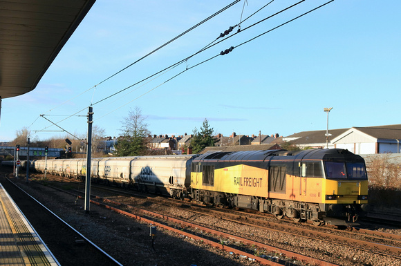 GBRf Class 60 No 60096 Skiddaw still in ex Colas livery passes Tyne & Wear Pelaw Station on 19.12.24 with 6N19 0959 Lynemouth Power Stn (Gbrf) to Tyne Coal Terminal Gbrf empty biomass hoppers