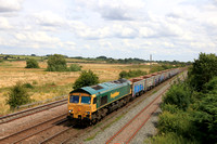 Freightliner Class 66 No 66546 approaches Melton Mowbray station on 26.7.24 with 6E68 1135 Chesterton Junction Fhh to Mountsorrel Sdgs empty MMA bogie open box aggregate wagons