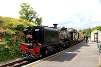 South African NG G16 No.87 waits at Beddgelert station, Ffestiniog and Welsh Highland Railways line on 15.6.24 with 1410 Caernarfon to Porthmadog 'The Harbourmaster ' service