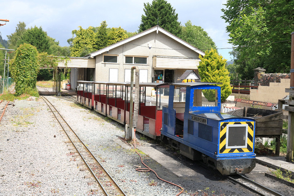 Diesel loco Gwydir Castle waits with a mini train at Conwy Valley Railway Museum miniature railway at Betws-y-Coed, in the Conway Valley seen on 5.7.24