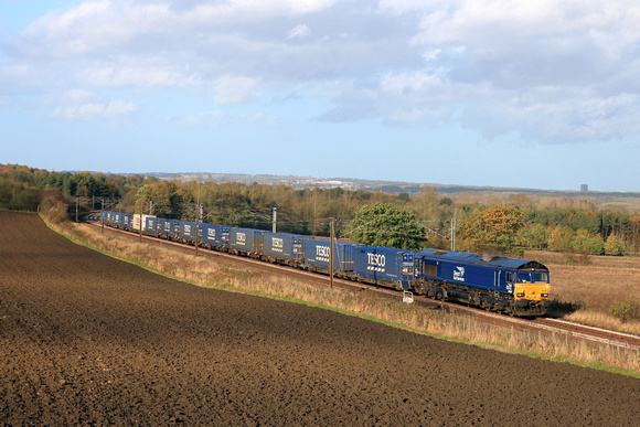 DRS Class 66 No 66108 powers past Plawsworth near Durham on 20.10.24 with 4E65 0952 Coatbridge (Drs) to South Bank Tees Dock (Drs) short Tesco Intermodal